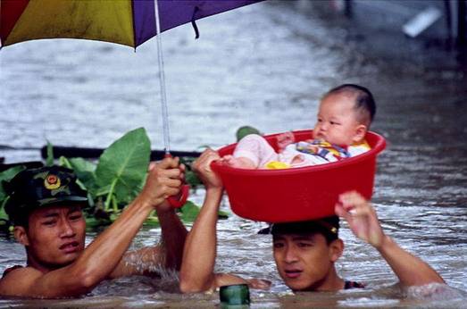 Child being rescued during flood